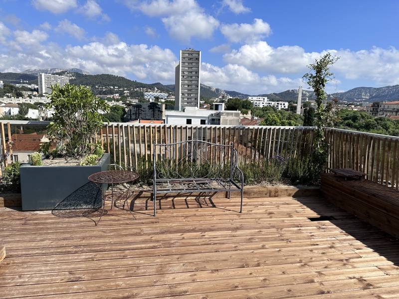  Aménagement d'un toit terrasse en ville avec terrasse en bois, pelouse synthétique et spa
